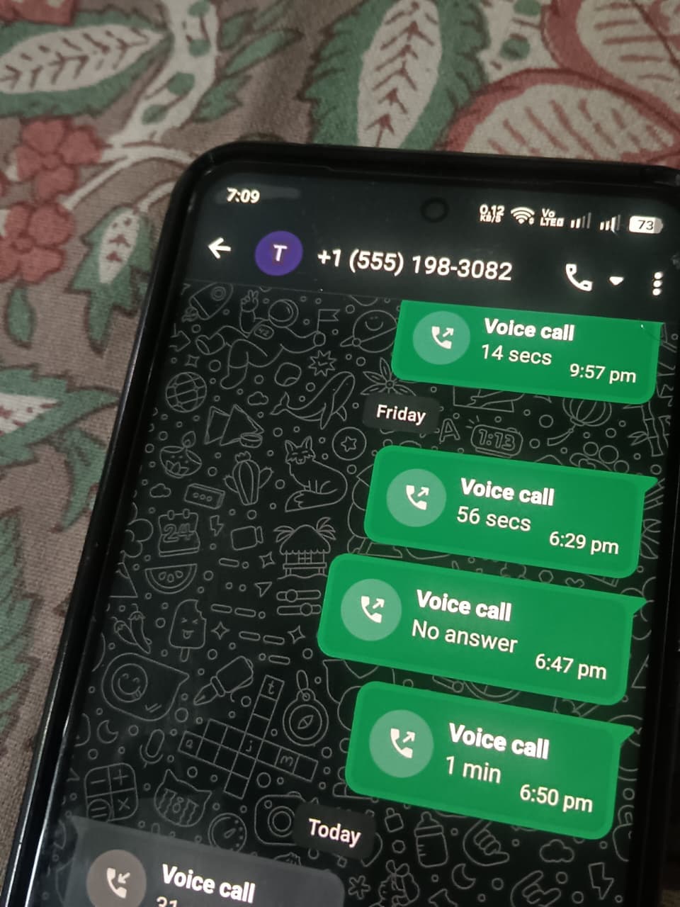 A phone showing a WhatsApp chat with a list of voice calls to the AI voice agent demo number